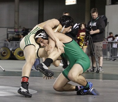 Kentwood’s Ruben Navejas works to tally more points in the 112-pound title match against Matthew Nguyen. He won 8-3