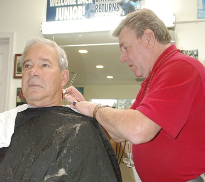 Doug Neer cuts Dennis Morasch’s hair at his barber shop in the Shady Park complex. Neer has been cutting hair in the area for more than forty years.   Kris Hill