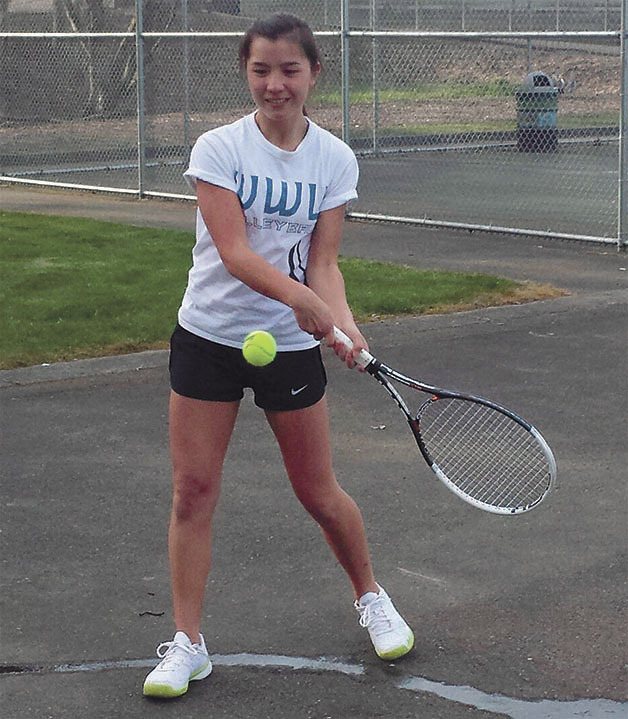 Kentwood sophomore Kathryn Araki practices hitting drills against a wall during practice on March 24.