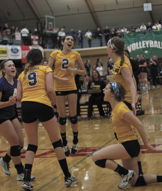 The team celebrates a momentous points during their match against Snohomish Friday.