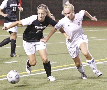 Kentlake's Paige Engeland fights Tahoma's Kaylee Osterman for the ball at midfield on Tuesday.