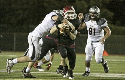 Kentlake’s Steffin Church tries to avoid a sack against Union in a 31-7 loss in the first round of state on Nov. 11.