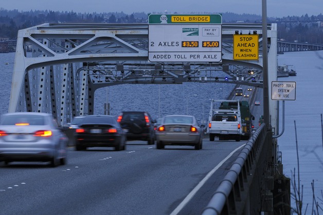 Traffic flows Westbound across the State Route 520 floating bridge on the first day of active tolling in this view from Medina on Thursday morning