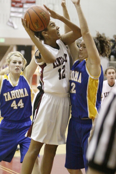 Kentlake's Morganne Comstock drives up to and charges Tahoma's Caitlin Nichols Tuesday