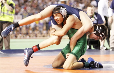 Kentwood's Ruben Navejas works to gain position over Rogers' Bryce Evans in an overtime period in the state title match at Mat Classic in February. He won the 103 pound weight class 4-2. This summer he has expanded his resume with wins in the USA Wrestling freestyle and Greco-Roman championships in New York.