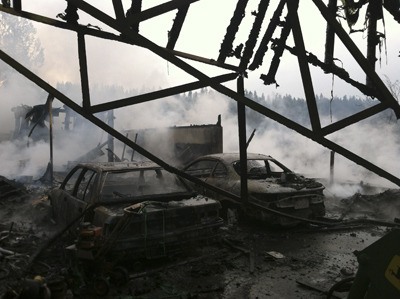 The remains of the barn and two vehicles after the fire on Green Valley Road March 25.