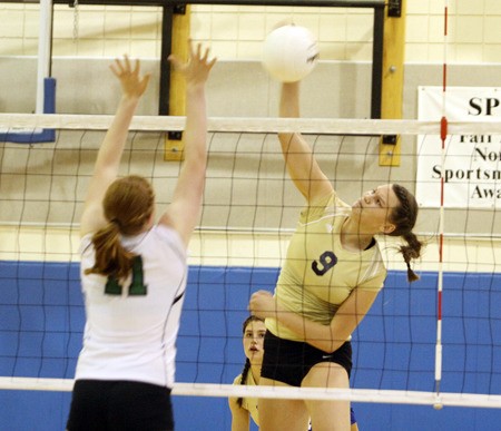 Tahoma's Megan Murrey goes for the kill over Kentwood's Katie Garlock in a league match on 22.