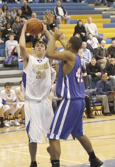 Tahoma’s Tim Parr puts in two over Kent-Meridian’s Martel Taylor Barone on Jan. 5.  Tahoma will play in the Kent Shootout on Friday.