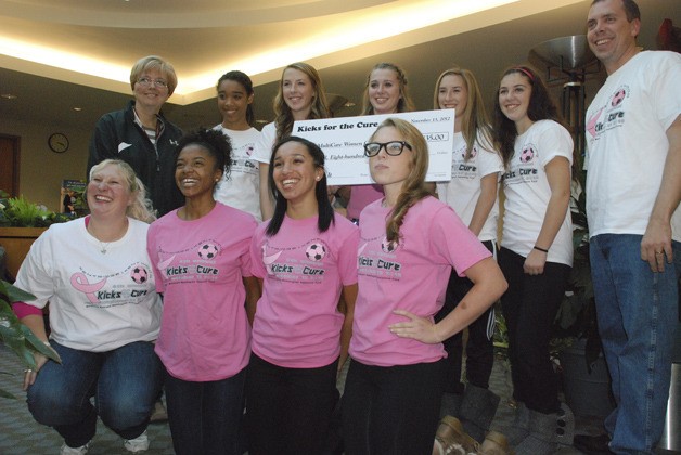 Kentridge and Kentwood girls soccer players presented a check Nov. 14 for more than $4