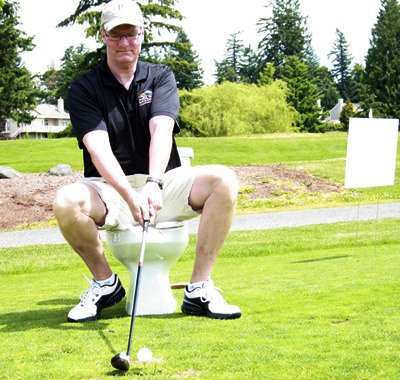 Kevin Patterson takes a swing during the wacky and wild golf challenge Friday at Lake Wilderness Golf Course.