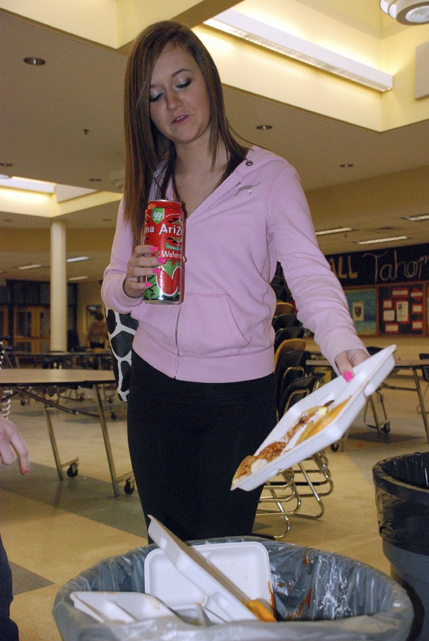 Tahoma High sophomore Tress Peifer empties a tray after lunch on Tuesday into the right bin. The school recently began composting food waste.