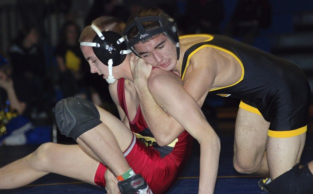 Tahoma’s Cruz Velasque tries to work Enumclaw’s Tyke Reid to his back to gain valuable points in the 113 point match during the Battle of the Bone on Jan. 27.