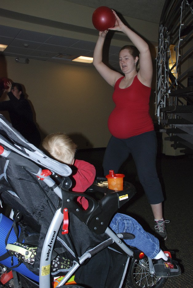 Christine Brower works out with Stroller Strides at Lake Wilderness Lodge in Maple Valley. Brower is less than two weeks away from her second child's due date.