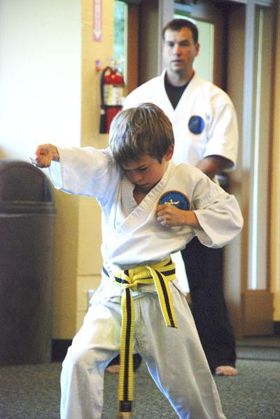 John Robinson watches as one of his students demonstrates his skills by going through a kata.