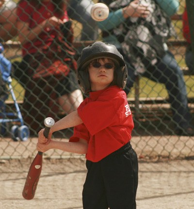 Charlotte Sweeney checks out a high pitch Saturday at the Black Diamond Elementary School field during the Maple Valley’s Pony Shetland baseball games. The Tigers team played the Lava Monsters.