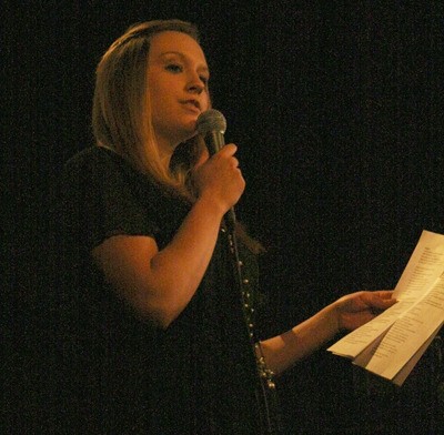 Malorie Spreen reads her poetry at the performance of 'War