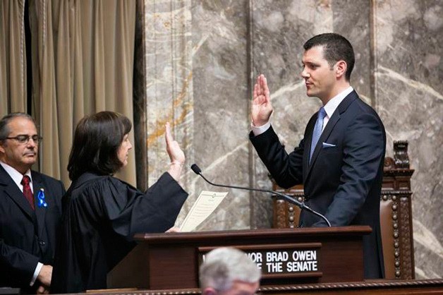 Senator Joe Fain being sworn in by Supreme Court Chief Justice Barbara Madsen.