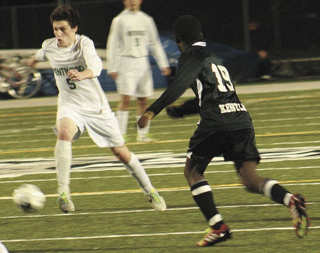 Kentwood senior Garrett Rudolph dribbled toward the goal during a 4-0 win against Kentlake on April 9. The Conks have started the season 6-0-2 after failing to make the playoffs in 2013.