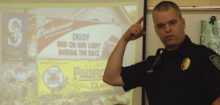 Black Diamond Police Officer Brian Lynch talks to students in Linda Reiter's fifth grade class about the subtlety of alcohol advertising.