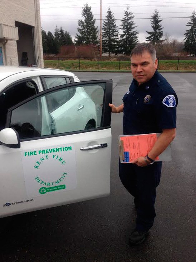 Capt. Phil Herrera poses next to one of the new Leaf vehicles the fire authority leased.