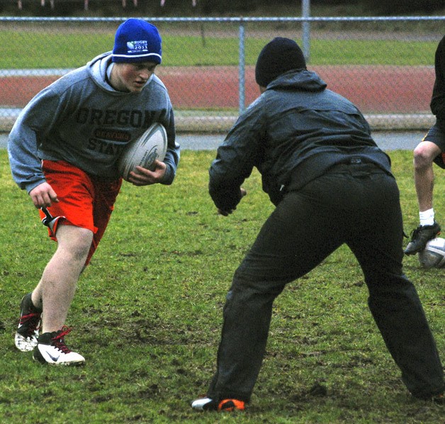 Hayden Warneke prepares to take on Crusaders coach Jeremy Torres during a ruck drill at practice Feb. 27 at Cedar Heights Middle School.