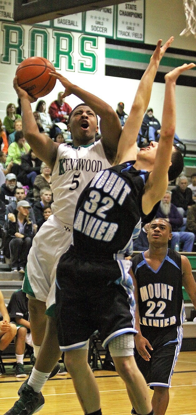 Kentwood's Jeremy Smith takes a shot over Mount Rainier's Caden Rowland. Smith had 10 points in the Conks 64-62 loss to the Rams.