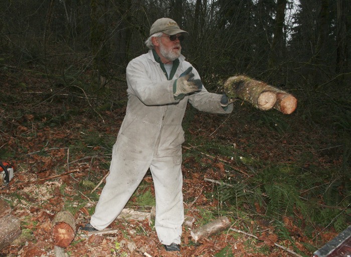 Mike Lovell clears some downed trees from his property near Black Diamond. The area has been hit by two wind storms in the past five days.