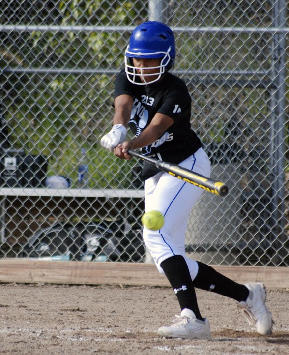 Tahoma's Mia Corbin slaps a single in a game against Kentwood Tuesday afternoon. The Bears defeated the Conquerors 2-1. Corbin scored to tie it 1-1 after this hit.