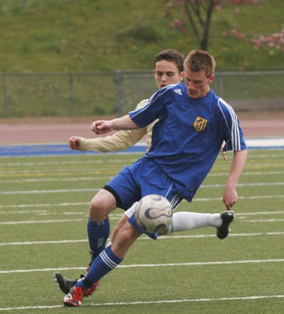 Tahoma senior Jason Downing works the ball down field Friday at French Field in a game against Kentridge. The Bears lost 2-1.