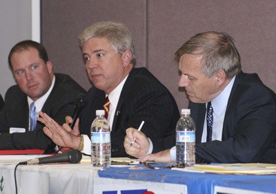 Rep. Glenn Anderson answers a debate question while Greg Hoover and David Spring listen Sept. 23 at Rock Creek Elementary.