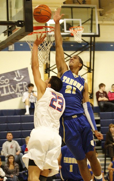 Tahoma’s Christian Behrens blocks a shot by Kent-Meridian’s Sergio Arroyo in a match up between the South Puget Sound League North division rivals Dec. 17 at Mill Creek Middle School. The Royals edged the Bears