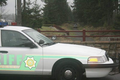 King County Sheriff's deputies block off the Lake Wilderness trail near the entrance to the Katesridge neighborhood in Maple Valley Tuesday afternoon following a shooting that left a 19 year old man and a 16 year old girl with bullet wounds.