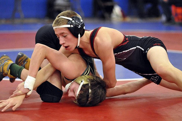 Kentlake’s Nick Smith works for points against Auburn’s Drew Aplin in the 106 pound subregional title match Feb. 2 at Kent-Meridian High. Smith