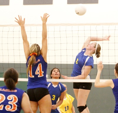 Tahoma middle hitter Megan Brothers gets a spike pass Grand Kapowsin's Joyce Vaiaga'e for a kill in in the first round of the West Central 4A Tournament