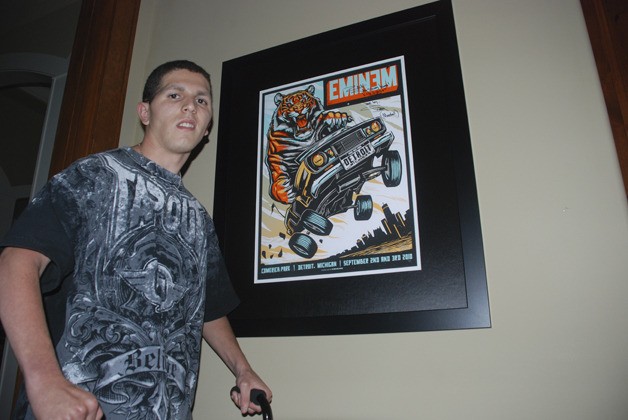 Zackery Lystedt with a poster signed by rapper Eminem which he received in a care package from the artist on the day he graduated from Tahoma High in 2011. Lystedt