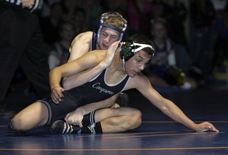 Tahoma's Steven Hopkins works to control the match against Kentwood's Ruben Nevejas in a 119 pound match on Dec. 9. It was the first league dual meet of the season for both teams.