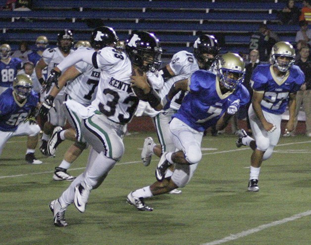 Kentwood running back Chaves Kalua-Fuimanono aces past a group of Tahoma defenders on Oct. 3. The Conks won 28-0