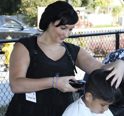 Natalie Lombardozzi volunteered to cut hair during the back-to-school barbecue.