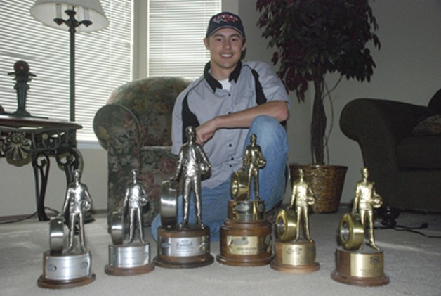 Dallas Glenn of Covington with his growing collection of NHRA race win trophies. He won his latest and biggest April 3 in Las Vegas.