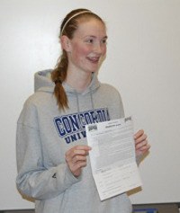 Kentlake’s Stephanie Luce shows off her letter of intent to Concordia University Nov. 26.