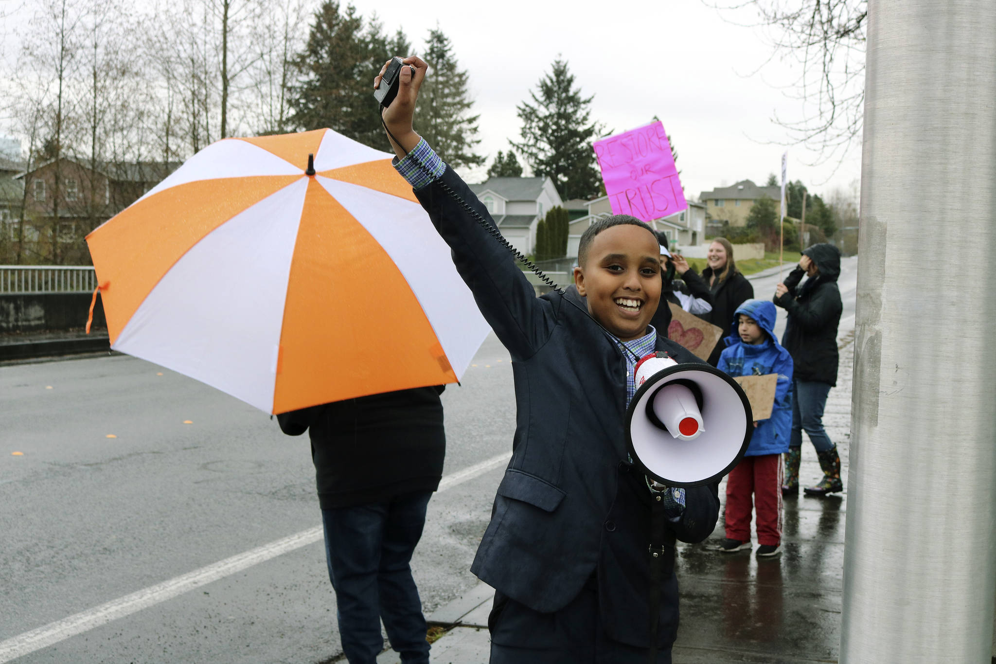 Scenic Hill fifth-grader Ismail Moalim leads the crowd in front of Kent School District headquarters with uplifting words at the April 4 rally to push for the superintendent’s resignation. He cites his teachers as his inspiration for attending the rally. Megan Saunders photo, for the Reporter