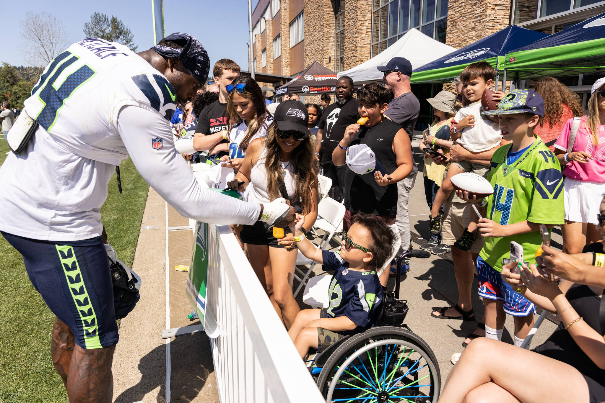 DK Metcalf shares a fist bump with a young fan. Photo provided by Maria Dorsten.