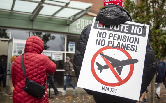 Larry Best, a customer coordinator for quality assurance who has worked at Boeing for 38 years, stands outside of Angel of the Winds Arena with a “vote no” sign on Monday in Everett. (Olivia Vanni / The Herald)